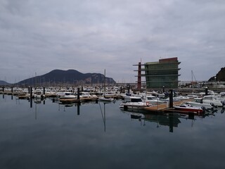 Fototapeta na wymiar Marina with boats moored on a cloudy day. Horizontal view. 