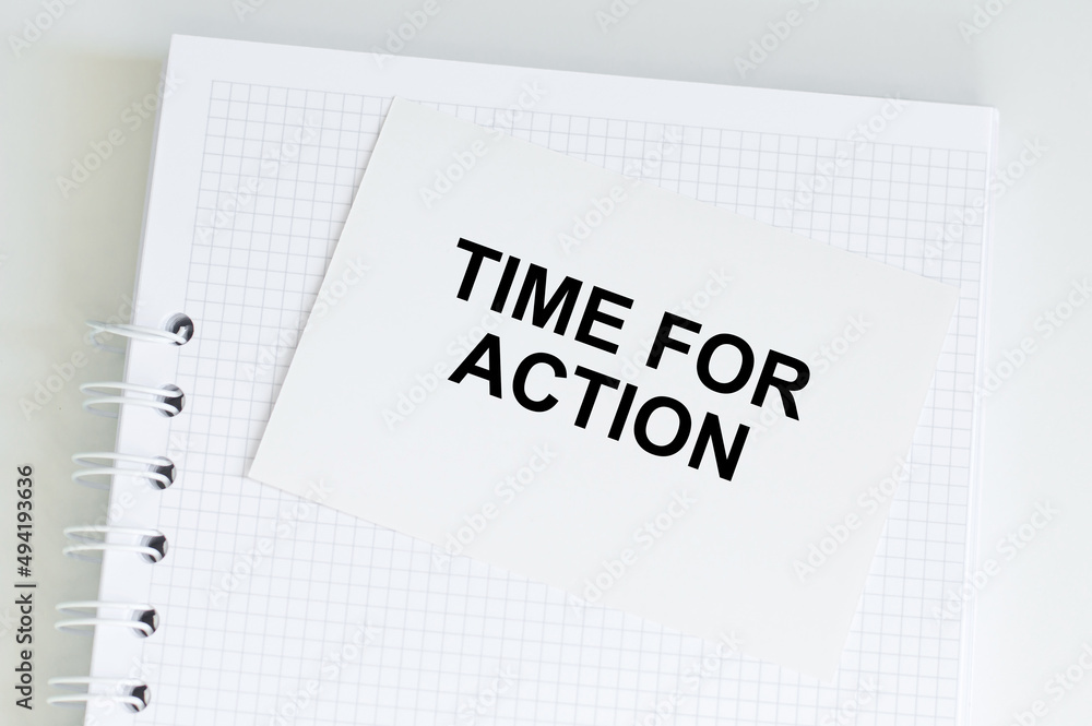 Poster a white card with time for action text on a white notepad on the table, business concept