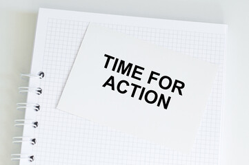 A white card with time for action text on a white notepad on the table, business concept