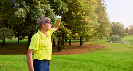 The player with a club in his hand, looks at the distance from the flag on a golf course, trying to...
