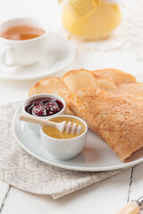 Pancakes with berry jam and honey
