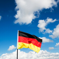 German flag waving against blue sky