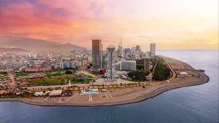 Drone photo of coast Batumi city at pink sunset - obrazy, fototapety, plakaty