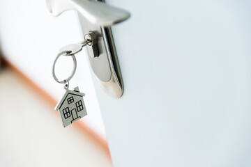 Key with house shaped keyring on door