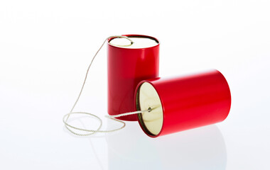 Red tin cans telephone isolated on white background