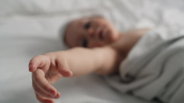 Close up of hands of cute caucasian baby after the bath. Shot with RED helium camera in 8K.