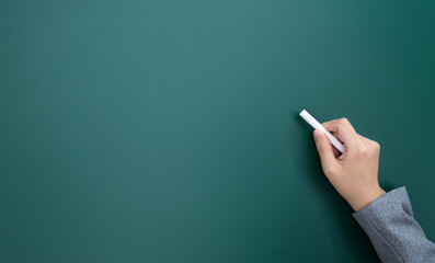 Businesswoman hand writing chalk on blackboard © xy