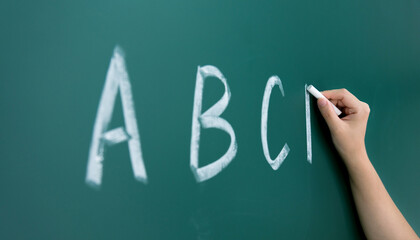 Alphabet abc hand chalk on blackboard