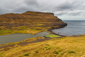 Small village Eidi situated on the slope of the mountain on Eysturoy island. Faroe Islands.