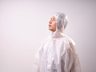 A health care worker wearing a mask and protective clothing on a solid color background