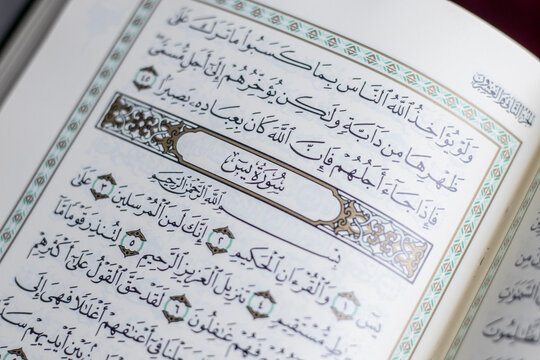 Asia,Indian,Pakistan. an open page of Quran shows Surah Yaseen on red background. Quran is an Islamic holy book for muslim. and ramadan is month of the quran.