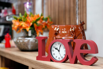 love lettering on clock in red color
