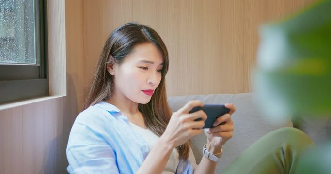 Asian woman play mobile games