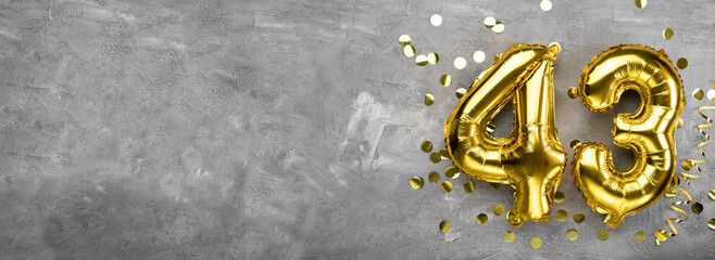 Yellow foil balloon number, number forty three concrete background. Greeting card with the inscription 43. Anniversary concept. for anniversary, birthday, new year celebration. banner,