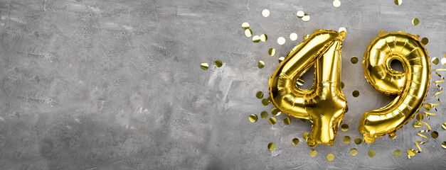 Yellow foil balloon number, number forty nine concrete background. Greeting card with the inscription 49. Anniversary concept. for anniversary, birthday, new year celebration. banner,