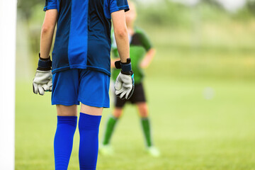 Fototapeta premium Youth Football Team Goalie Staning in a Goal Ready to Play and Save