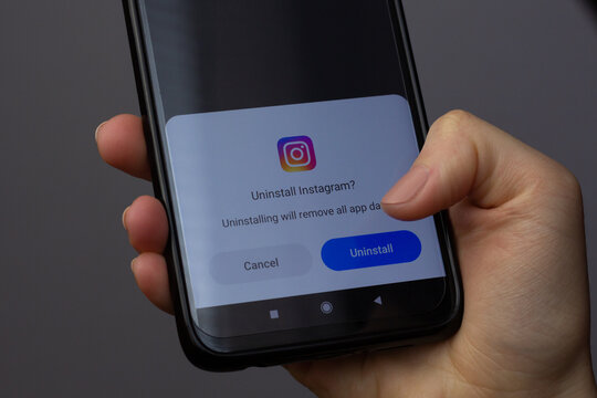 Katowice, Poland – March 20, 2022: A person is deleting Instagram app.