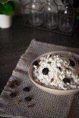 Ceramic dishes with a dairy product on a kitchen wooden table.
