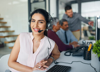 Call us for a professional service. Portrait of a young woman working in a call centre.