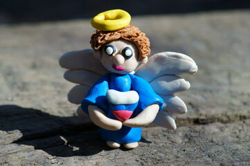 Obraz premium A toy angel with a heart in the colors of the Russian flag.