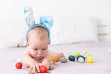 Fototapeta na wymiar Newborn baby girl in a rabbit ears. Easter Holiday