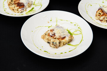Chief serving potato gratin with chanterelles mushrooms and cheese in a restaurant