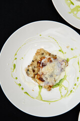 Chief serving potato gratin with chanterelles mushrooms and cheese in a restaurant