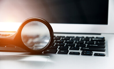 Magnifying glass on the laptop keyboard