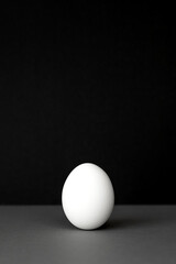 Egg on a black and gray background. Easter concept.