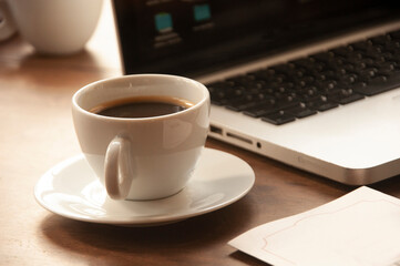 coffee cup with notebook on wooden table