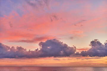 Naklejka na ściany i meble Landscape of paradise serene calm gradient pink idyllic sky with fluffy clouds