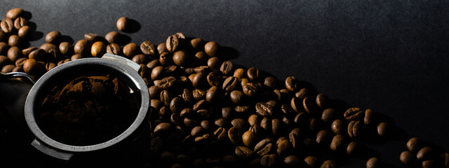 Coffee beans in the coffee horn on the background of coffee beans