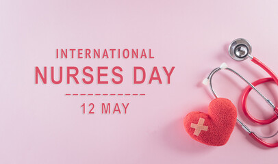 Top view of doctor stethoscope and red heart on pastel background. International nurse day and medical concept.