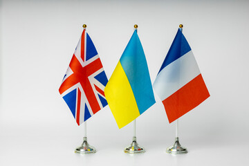 National flags of Great Britain, France and Ukraine on a light background. State flags.