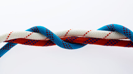 Twisted colorful ropes against white background