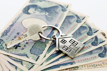House key over japanese banknotes