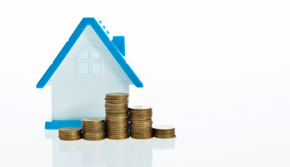 View Of coin stack with house model against white background