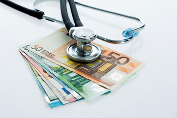 Stethoscope and money euro cash isolated on white background