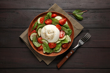 Delicious burrata salad served on wooden table, flat lay