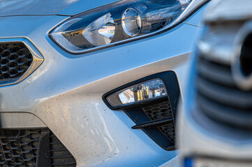 Closeup of headlights of cars standing in a row, aelective focus
