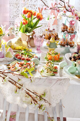 Vintage style interior with Easter table with dishes and decorations