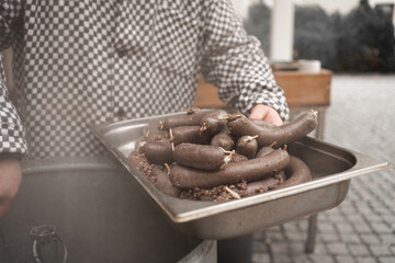 hands of a person and liverwursts