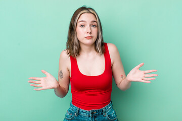 pretty caucasian woman feeling puzzled and confused, unsure about the correct answer or decision,...