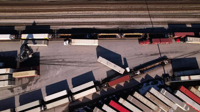 Reach stacker at work in logistic center of Vancouver terminal in Canada. Aerial top down view