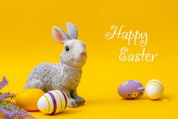 Easter bunny with an egg on a yellow background. Easter card.