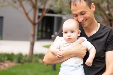 Father and his son walking at summer park