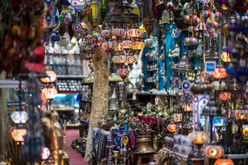 Fototapeta premium Muscat,Oman - March 05,2019 : All kinds of souvenirs exhibited in market shops of the old town Mutrah.