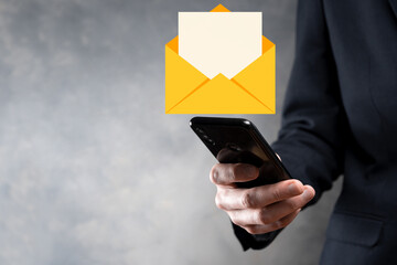 Businessman hand holding e-mail icon, Contact us by newsletter email and protect your personal...