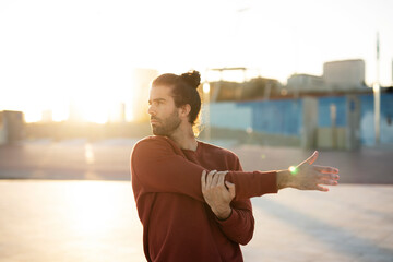 Young muscle man training outside. Fit handsome man doing exercise.