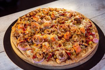 seafood pizza with salmon and caramelized onion